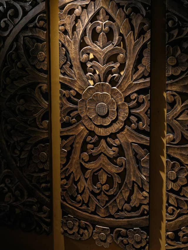 Dark door with deep floral carving