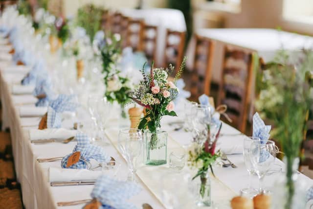 Long table dressed with linen and wildflowers
